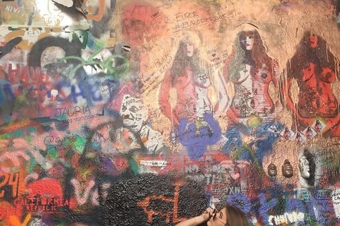 Student looks up at art